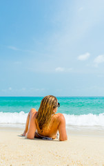 Woman suntanning on the beach on the tropical beach