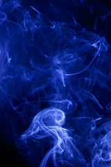 Blue smoke on a black background.