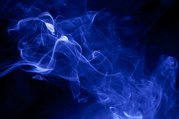Blue smoke on a black background.