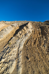 Folded layered rock outcrop, geologic crustal movement