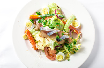 Salad with mackerel fish, zucchini, lettuce, carrots and creamy dressing 