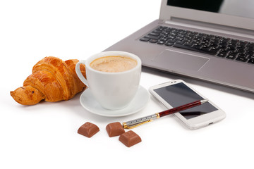 cup of coffee, croissant and laptop