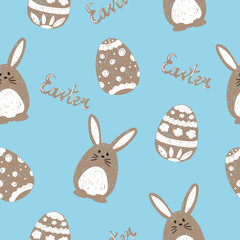 Obraz premium Cute Easter rabbits and eggs on blue. Easter seamless pattern. Holiday background with bunnies. 