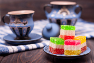 jelly sweet with tea cup on wooden background