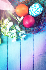 Easter concept with colorful eggs on wooden background