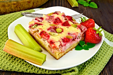 Pie strawberry-rhubarb with cream on green napkin