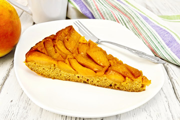 Pie with pears and honey in plate on light board