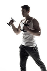 Fototapeta na wymiar Muscular man doing exercises with dumbbells isolated on white background