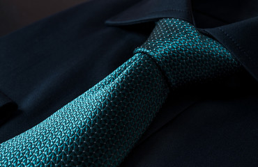 Blue folded shirt with a gray tie isolated on white background