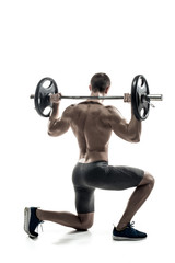 Naklejka na ściany i meble Fitness man standing on knee and holding barbell, rear view
