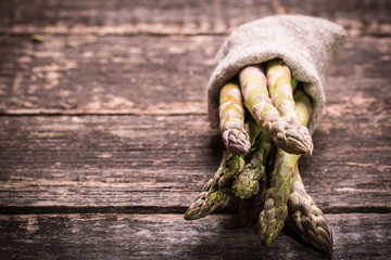 Fresh asparagus on wooden table , diet concept