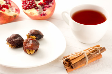 Obraz na płótnie Canvas flower tea, oriental sweets - hashtak, cinnamon and pomegranate