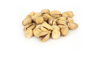 tasty pistachios heap against close up white background