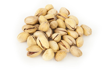 tasty pistachios heap against close up white background