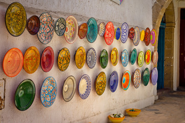 Traditional colorful Moroccan plates on the street walls of Marrakesh.