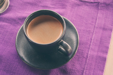 Coffee cup on breakfast table, vintage warm color tone.