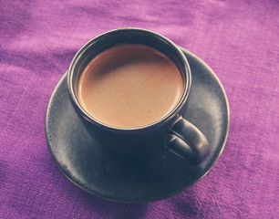 Coffee cup on breakfast table, vintage warm color toned image, s