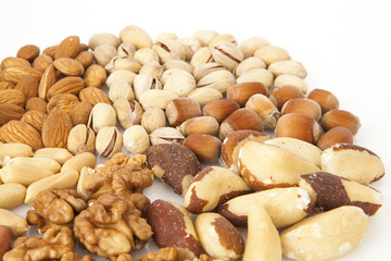 Mixed nuts - almonds, pistachios, hazelnuts, brazil nuts, walnuts, peanuts on the white background, circle, rounded on top