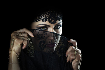 Beautiful caucasian young woman with black veil on face