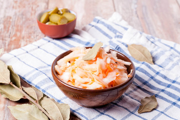 Sauerkraut with carrot in brown bowl