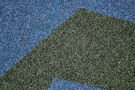 Texture. Childrens playground floor.Rubber and stones.