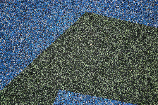 Texture. Childrens playground floor.Rubber and stones.