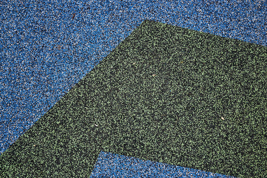 Texture. Childrens playground floor.Rubber and stones.
