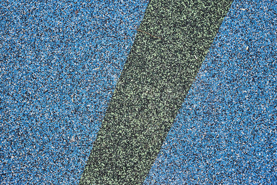 Texture. Childrens playground floor.Rubber and stones.