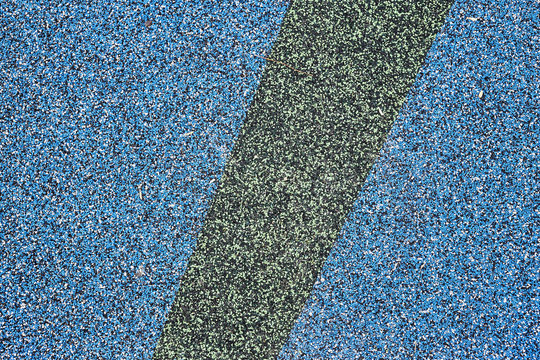 Texture. Childrens playground floor.Rubber and stones.