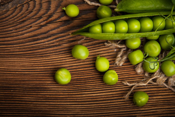 Fresh organic green peas on a wooden background.Rustic style.