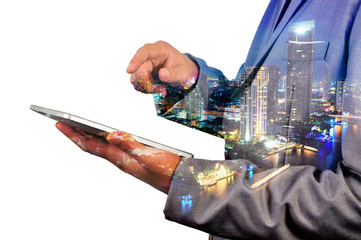 Double Exposure image of Businessman use Digital Tablet and City