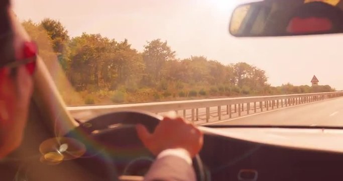 Slow Motion Shot Of Middle Aged Caucasian Male Driving His Car During Beautiful Sunset