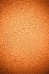Orange background. background drops of water on clear glass..