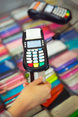 Female hand doing purchase through payment machine