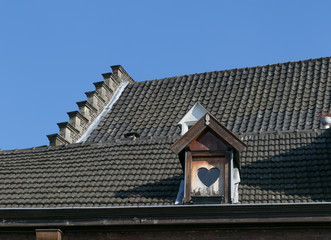 a roof with a heart window