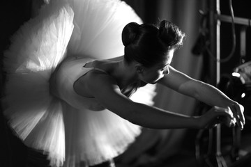 Beautiful ballerina warming up on backstage