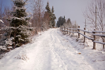 Snow-covered ground road in the countryside