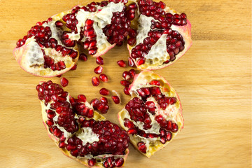 Ripe pomegranate fruit on wooden background