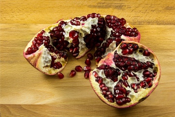 Ripe pomegranate fruit on wooden background