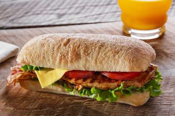 Sandwich with grilled chicken tomato bacon cheese 