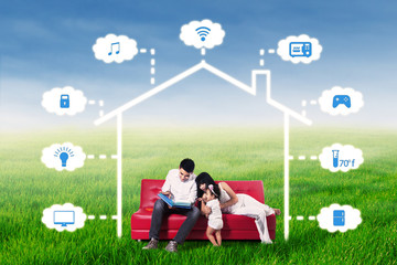 Family read book under an illustration of smart house