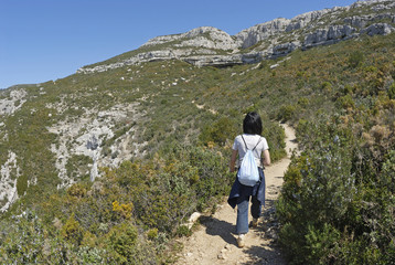 Naklejka na ściany i meble Woman hiking in the Sainte-Baume Mountains, Provence, France, Europe