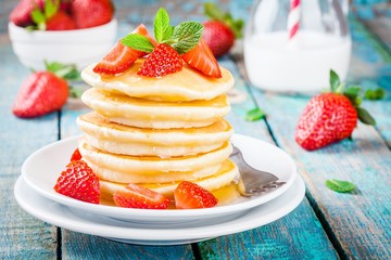 Homemade pancakes with honey and strawberries