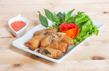 Fried Chinese Traditional Spring rolls food isolated on wood bac