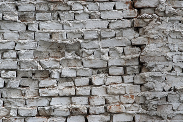 The wall of the old house from the brick and plaster painted in