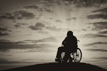 Fototapeta na wymiar Silhouette of disabled person in a wheelchair