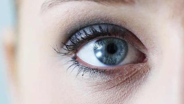 Macro close up of female eye blinking, beauty and health concept