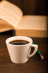 cup of coffee with book in coffee shop