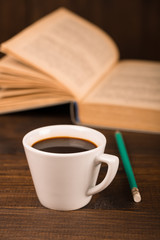 cup of coffee with book in coffee shop