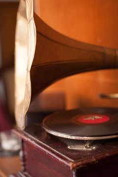 Old gramophone with golden horn and wooden body